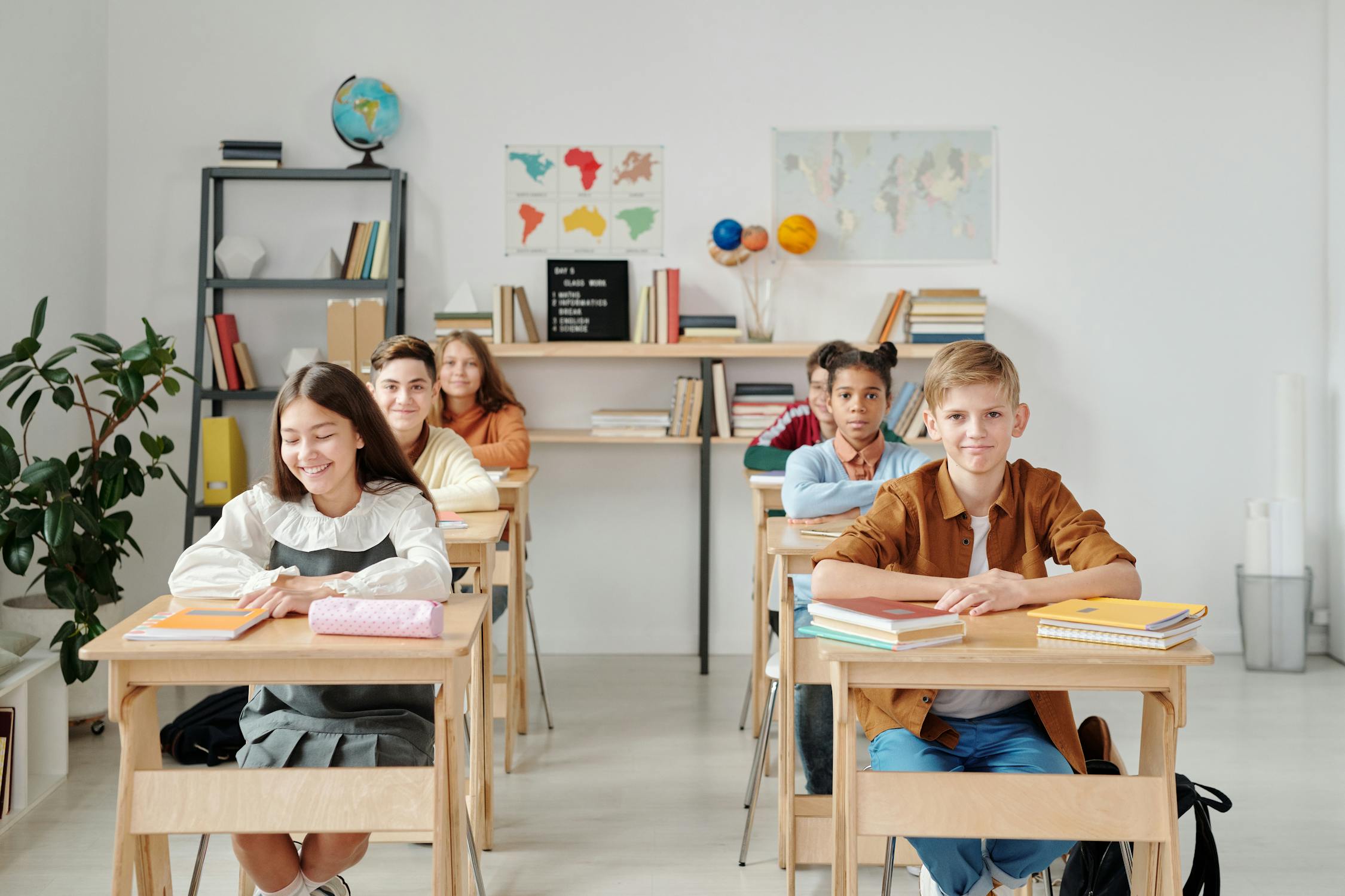 Students writing together with a tutor in a cozy study room